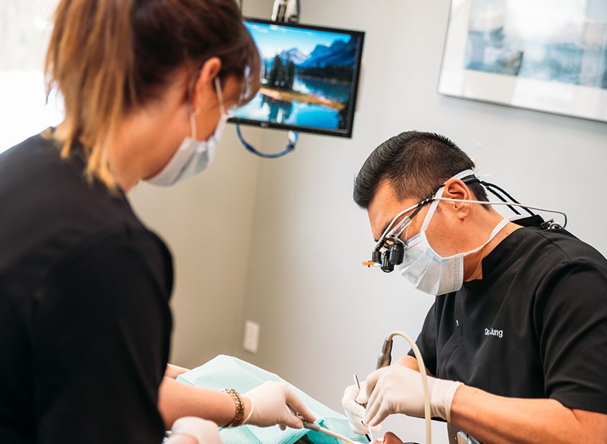 dentist and dental assistant working on patient using your dental benefits before year end