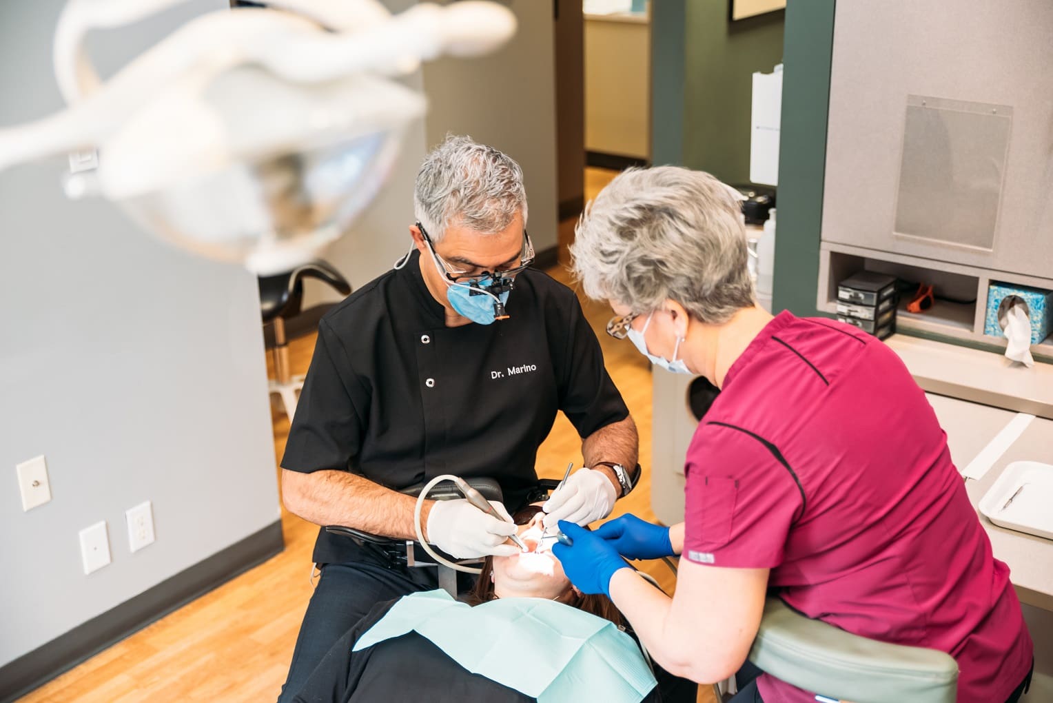 dentist and hygienist working on patient iv sedation dentistry 