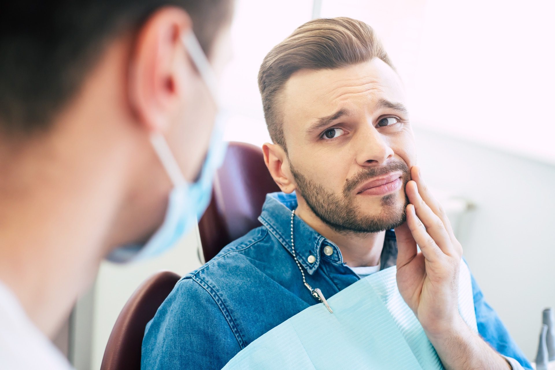 Man at dentist suffering from cavity