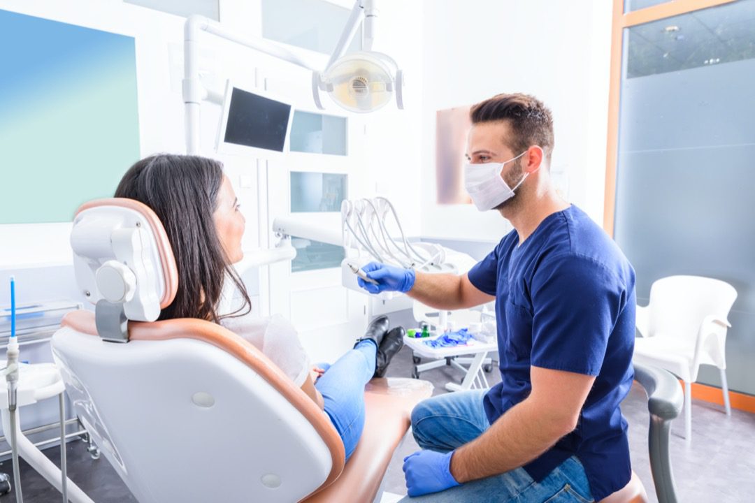 Dentist speaking with client about dental headache