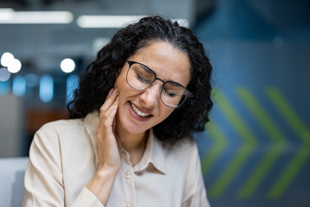 Woman experiencing headache after dental work  