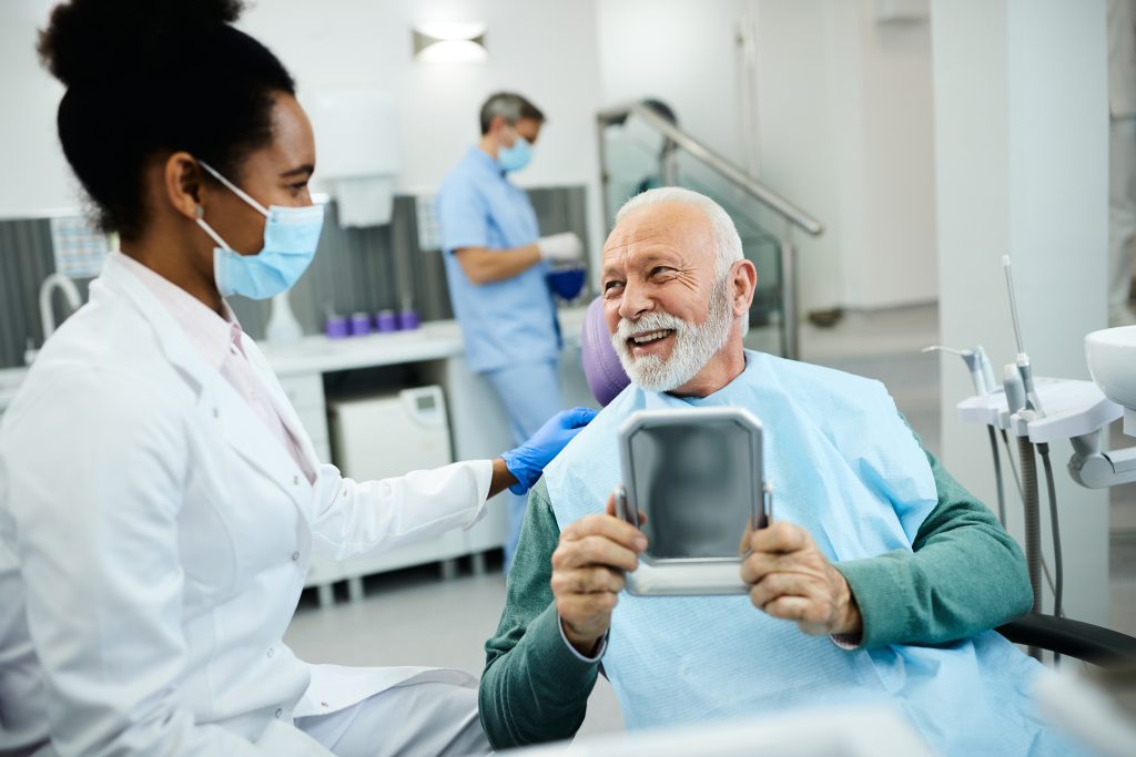 Patient talking to dentist at Enamel Dental Centre Penticton about dental implant care